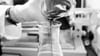 Liquid is poured from one beaker into another in a laboratory