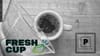 A Chemex pouring coffee into a cup on a table, seen from above, overlaid with logos for Fresh Cup Magazine and The Pourover