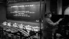 A worker at a Starbucks Reserve Roastery operates a machine