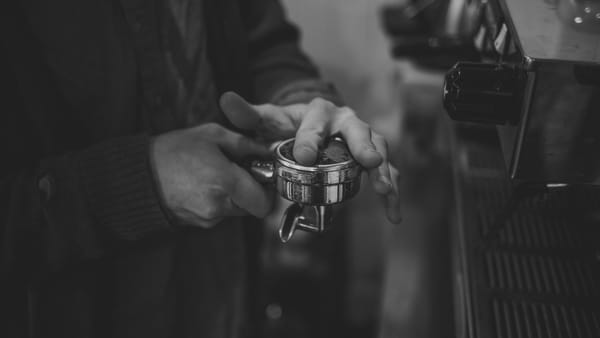 Closeup of a barista preparing a portafilter before brewing espresso